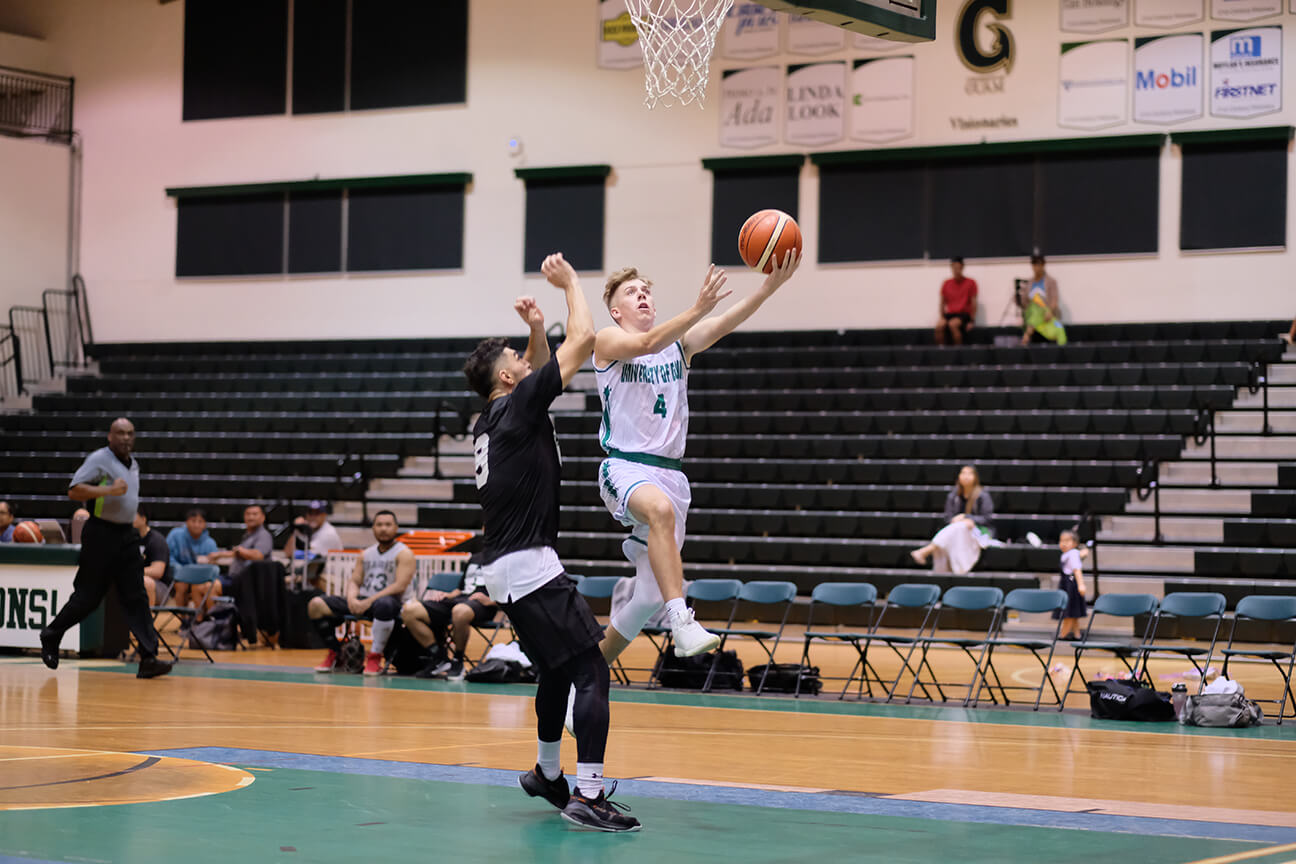 UOG Tritons’ Jerod Boles drives to the hoop past a Team Wu-Tang defender in a Nov. 20 matchup. 