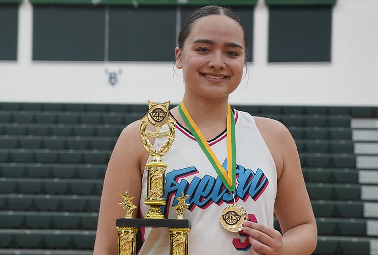 Mia San Nicolas poses with trophy and medal