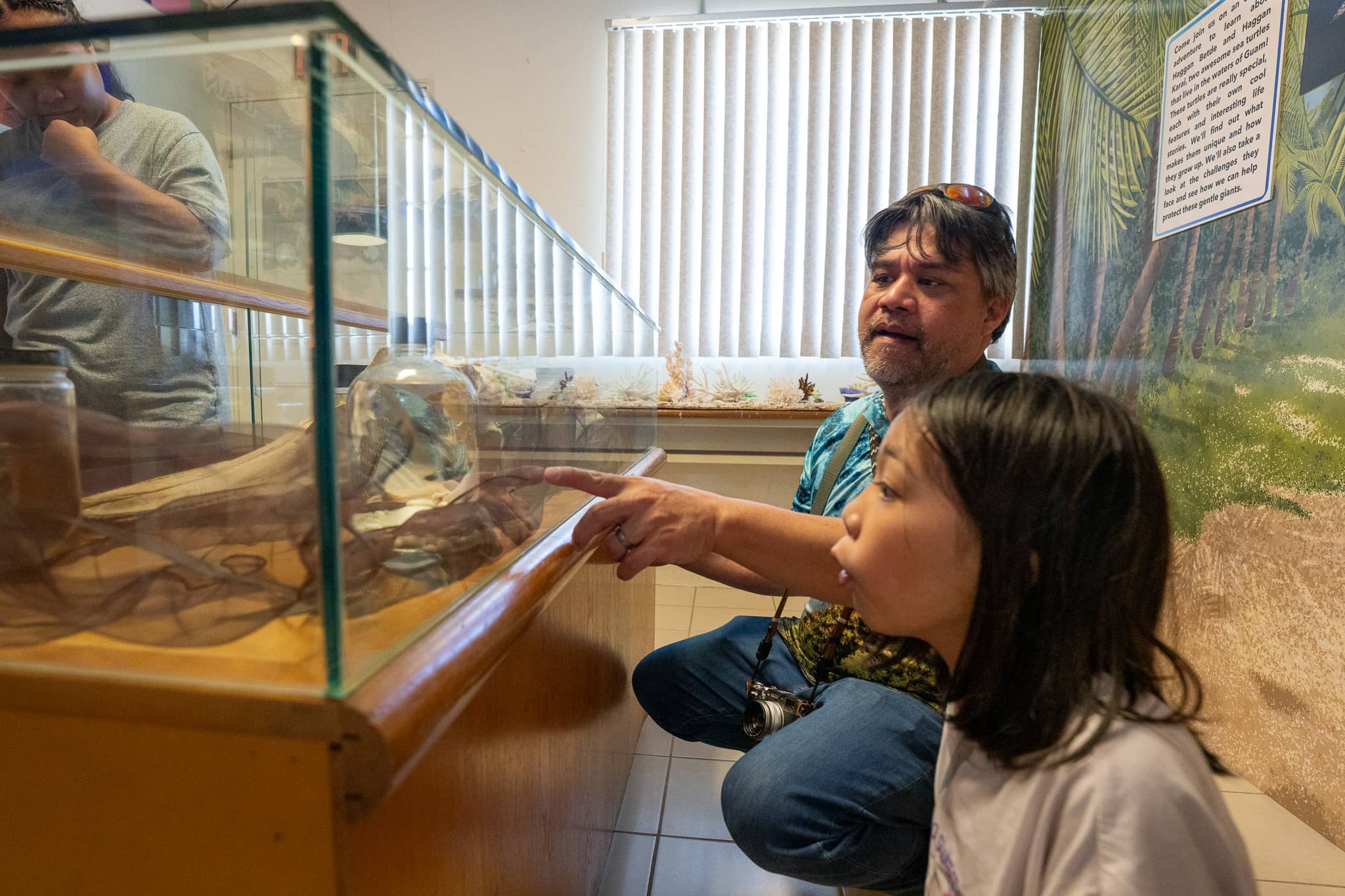 Elementary school student Naomi Grapa is in awe while learning about the animals of Guam and looking at preserved specimen at the launch of the Chalan Deskubre Hub at the University of Guam.  Grapa also contributed a drawing of a Sihek for display.  The Hub is open to the public via reservations and can host students, small groups and individual visitors.