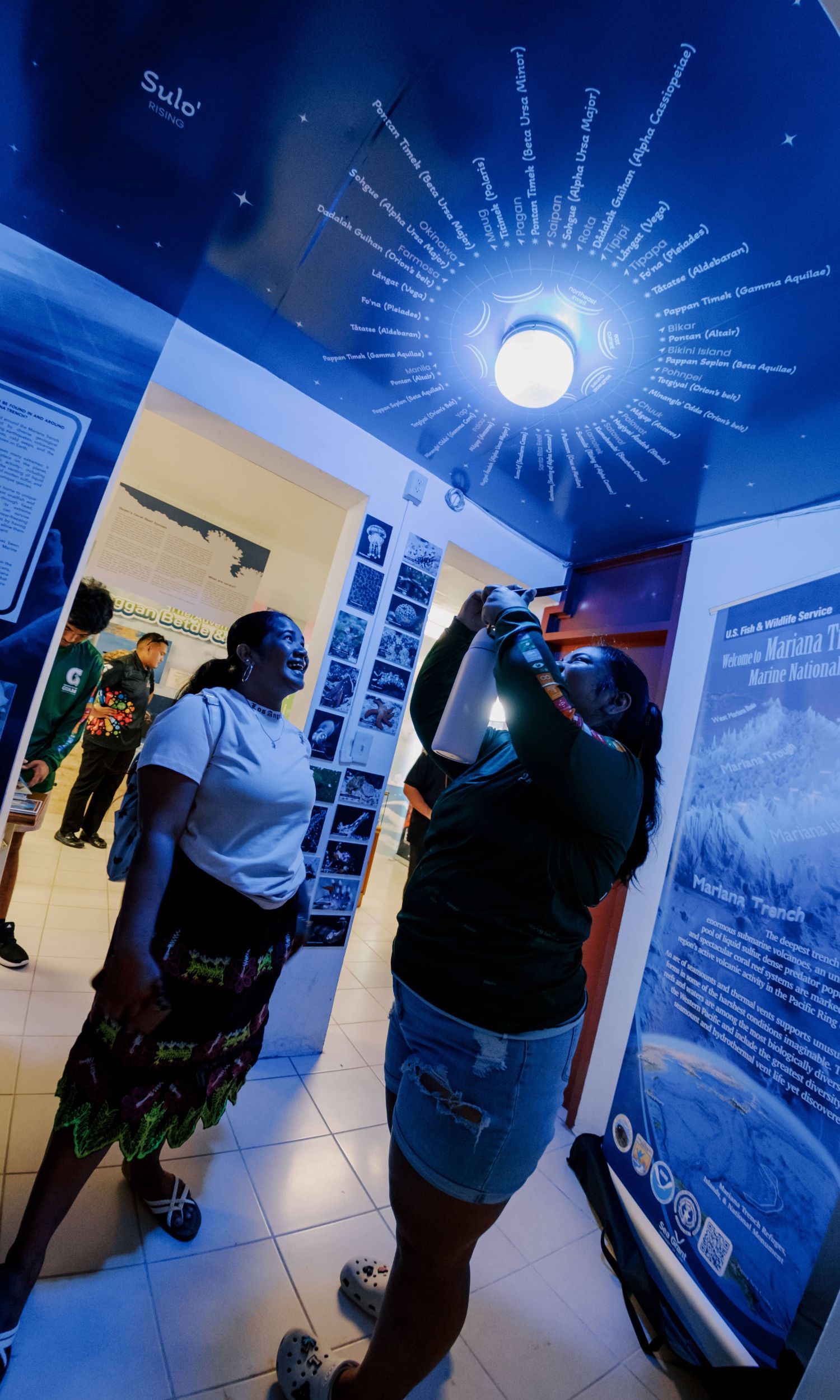 UOG students are inspired while looking at the Guam star map exhibit at the CHalan Deskubre Hub.  The map was developed based of the lessons of Master Navigator Larry Reigetal who teaches traditional navigation.  The Hub is located on the second floor of the post office building at Dean Circle at UOG and is open for tours via reservations