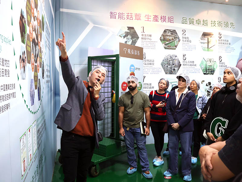Photo of a tour group in a mushroom production facility