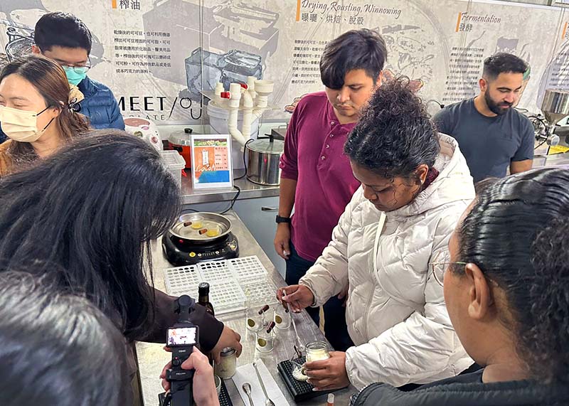 A photo of students making lip balm from cacao 