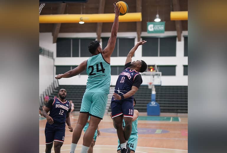 Backetball player #24 from Team Austability makes shot while opponent attempts a block