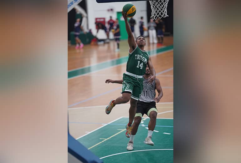 UOG Tritons player #14 goes for shot with opponent behind